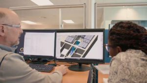 | `Etude.jpg` | Deux ing&eacute;nieurs devant des plans 3D sur double &eacute;cran (logo Orano visible) | `Ing&eacute;nieurs analysant des plans 3D sur double moniteur, vid&eacute;o m&eacute;tier pour bureau d'&eacute;tudes industriel Orano` |