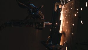 | `Laser.jpg` | Robot de d&eacute;coupe laser projetant des &eacute;tincelles sur une pi&egrave;ce m&eacute;tallique | `Robot de d&eacute;coupe laser industriel projetant des &eacute;tincelles sur m&eacute;tal, vid&eacute;o corporate industrie haute technologie` |